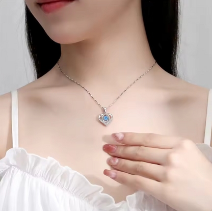 Silver-tone necklace with blue heart pendant