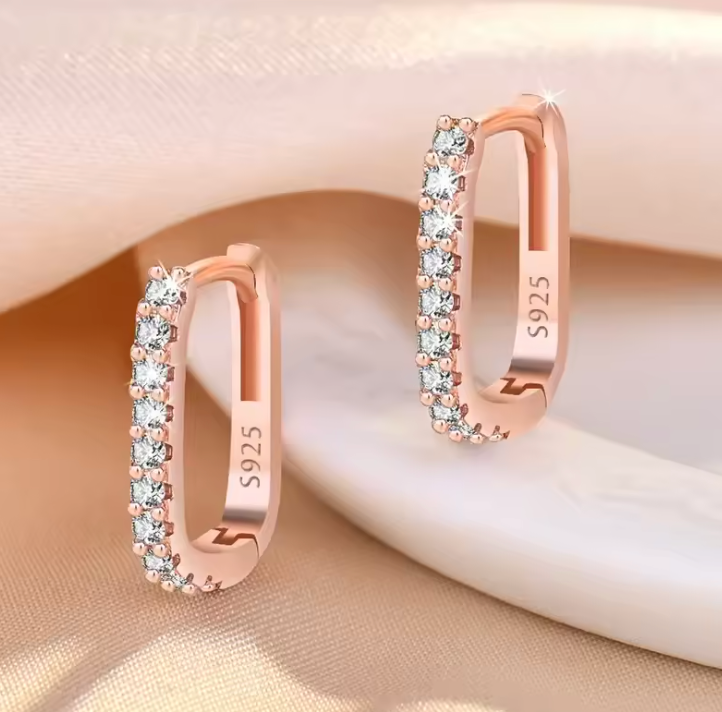 Rose gold tone earrings on satin
