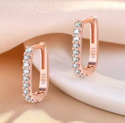 Rose gold tone earrings on satin