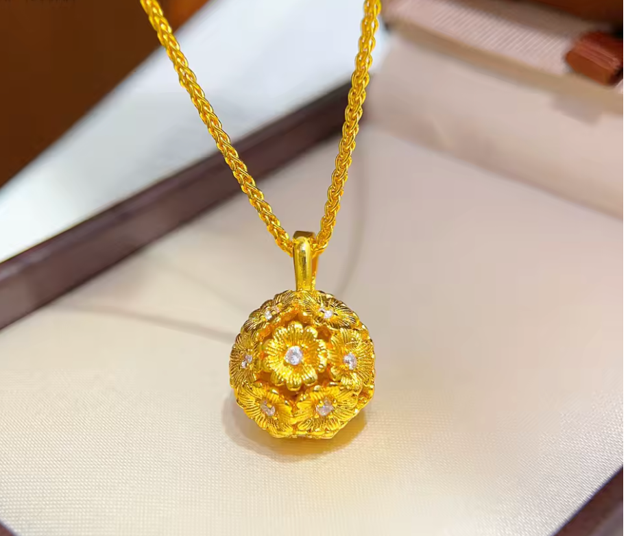Gold-tone floral orb pendant suspended from chain