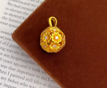 Gold-tone flower-patterned spherical pendant close-up