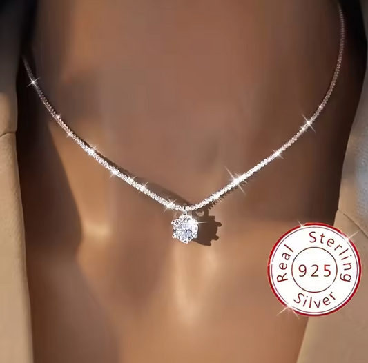 Solitaire pendant necklace worn against dark neckline