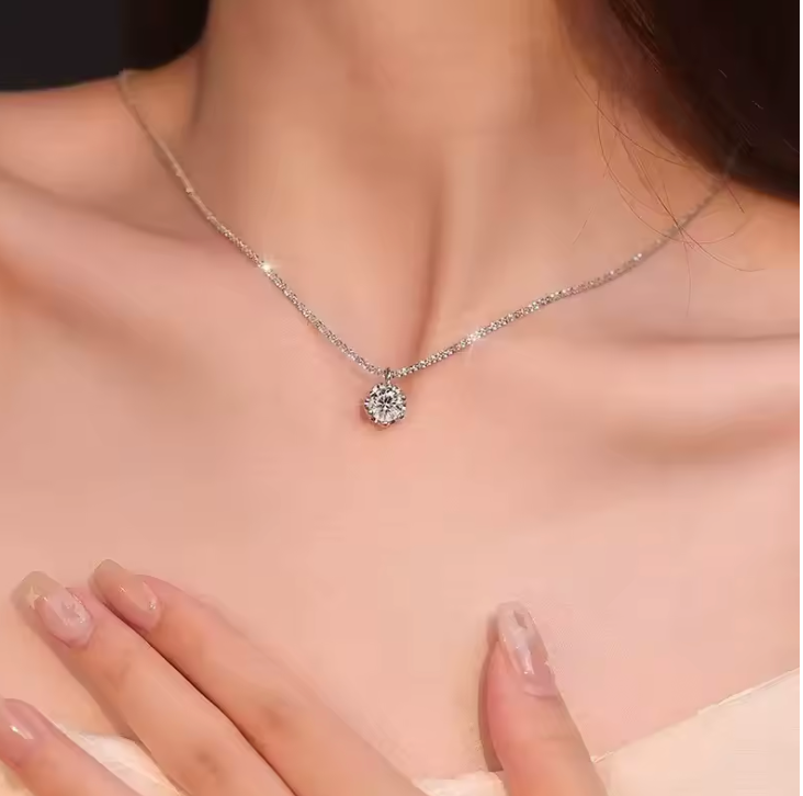 Solitaire necklace worn with white outfit