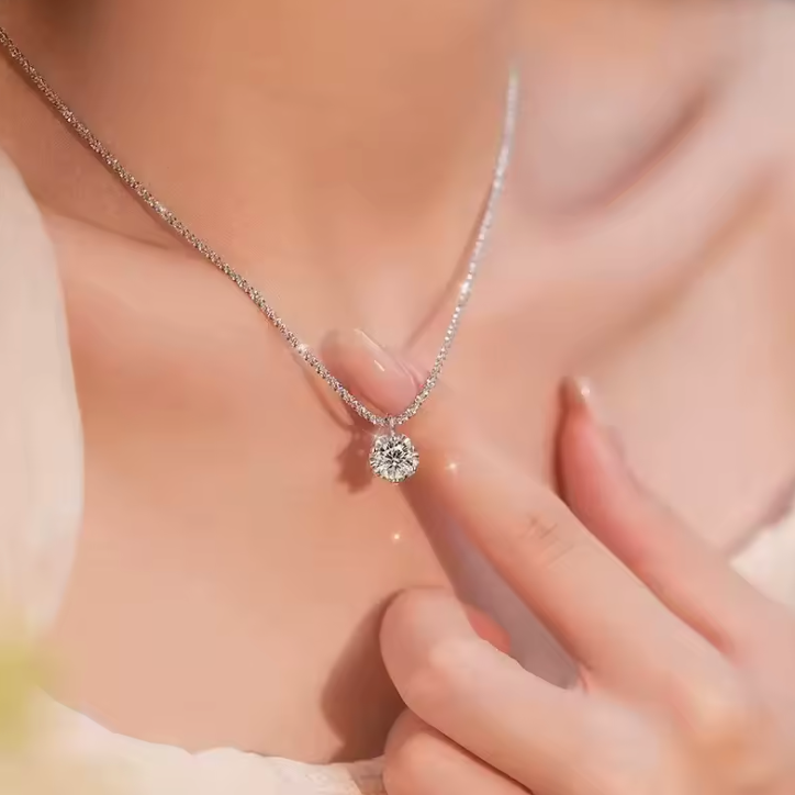 Clear-stone pendant necklace close-up on model